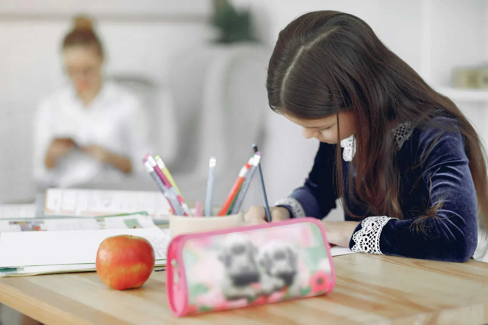 Parent and child working together at a table